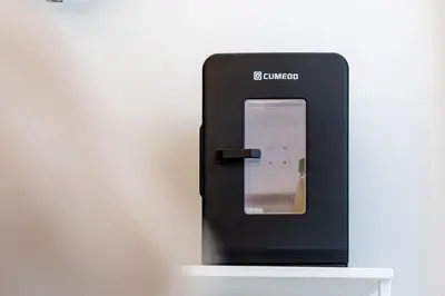 a cell phone dispenser sitting on top of a shelf at Vatican LeM collection in Rome