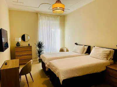 a bedroom with two beds and a table and a desk at Borgo Pio Suite Apartment in Rome