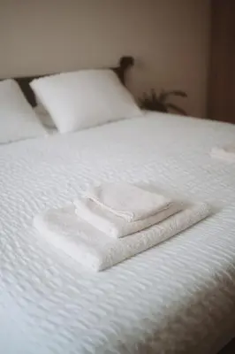 two towels are sitting on top of a white bed at Borgo Pio Suite Apartment in Rome