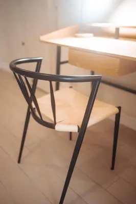 a black chair sitting next to a wooden table at Borgo Pio Suite Apartment in Rome