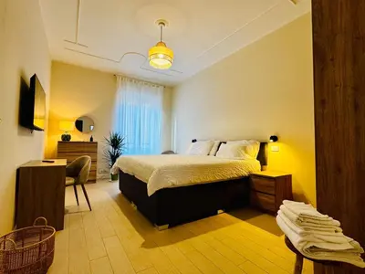 a bedroom with a bed and a desk and a chair at Borgo Pio Suite Apartment in Rome