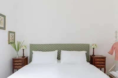 a bedroom with a white bed and two night stands at iFlat Historic Charm & Comfort by Piazza Navona in Rome