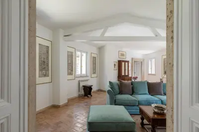 a living room with a blue couch and a table at iFlat Historic Charm & Comfort by Piazza Navona in Rome