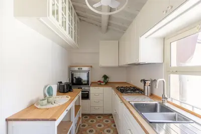 a kitchen with white cabinets and a sink at iFlat Historic Charm & Comfort by Piazza Navona in Rome