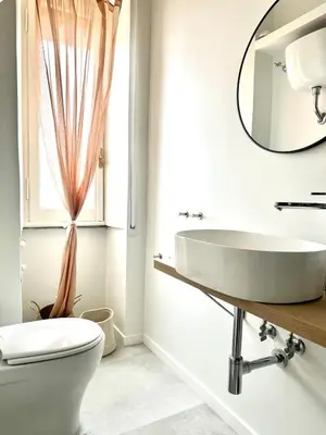 a white kitchen with a sink and two windows at Casa Mazz San Giovanni in Rome