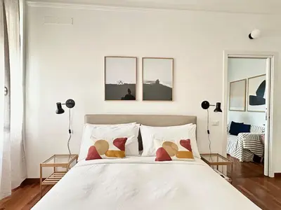 a bedroom with a large white bed with pillows at Casa Mazz San Giovanni in Rome
