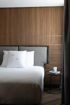 a bedroom with a bed and a side table at Palazzo 4 Fontane 12 in Rome