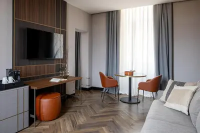a hotel room with a couch and a table at Palazzo 4 Fontane 12 in Rome