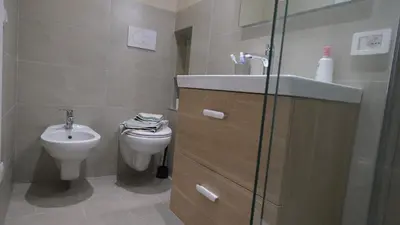 a bathroom with a sink and a toilet at B&B Caput Mundi in Rome