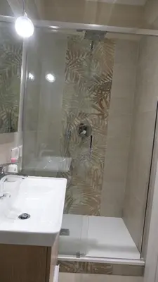 a bathroom with a shower with a sink and a toilet at B&B Caput Mundi in Rome