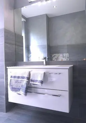 a bathroom with a white sink and a mirror at B&B Caput Mundi in Rome