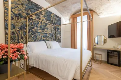a bedroom with a canopy bed and a wall mural at Scipioni 235 Luxury Suite in Rome