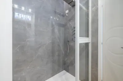 a bathroom with a shower and a toilet at Scipioni 235 Luxury Suite in Rome