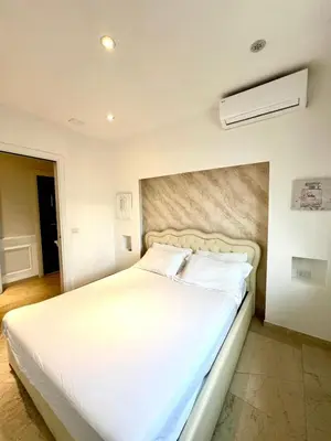 a bedroom with a large bed with white sheets at San Pietro APT near Vatican city Roma in Rome