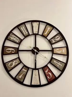 a clock with roman numerals on a wall at San Pietro APT near Vatican city Roma in Rome