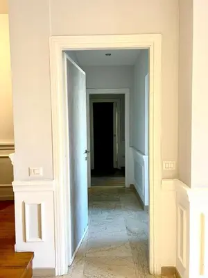 an empty hallway with a door leading into a room at San Pietro APT near Vatican city Roma in Rome