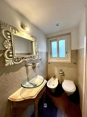 a bathroom with a sink and a toilet and a mirror at San Pietro APT near Vatican city Roma in Rome