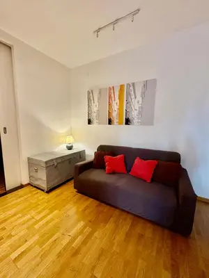 a living room with a couch and a table at Loft in Colosseum, style in the heart of Rome! in Rome