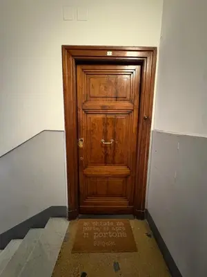 a wooden door in the middle of a room at Loft in Colosseum, style in the heart of Rome! in Rome