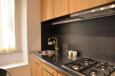 a kitchen with a stove and a counter top at Loft in Colosseum, style in the heart of Rome! in Rome