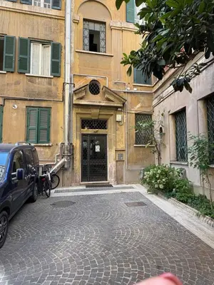 a car parked in front of a building with a door at Loft in Colosseum, style in the heart of Rome! in Rome