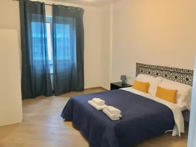 a bedroom with a bed with two towels on it at San Peter-Vatican Way in Rome
