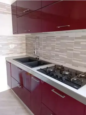 a kitchen with red cabinets and a sink at San Peter-Vatican Way in Rome