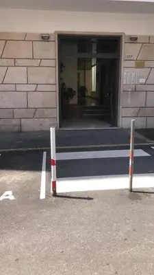 two poles in the street in front of a building at San Peter-Vatican Way in Rome