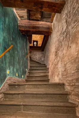 a stairway in an old building with a wooden ceiling at Locanda da Enzo in Rome