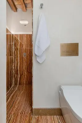 a bathroom with a shower with a wooden floor at Locanda da Enzo in Rome
