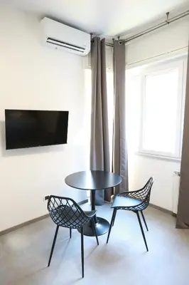 a table and two chairs in a room with a tv at Unique Stay Tiburtina in Rome