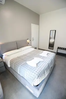 a bedroom with a large bed with two white pillows at Unique Stay Tiburtina in Rome