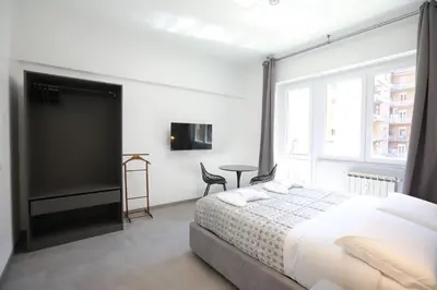 a bedroom with a bed and a large window at Unique Stay Tiburtina in Rome