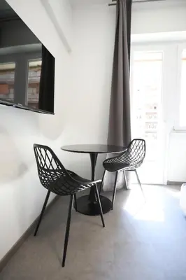 a table and two chairs in a room at Unique Stay Tiburtina in Rome