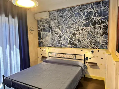 a kitchen with blue and white tiled walls at The Attic Penthouse Rome Cozy & Comfy Close to Trastevere & Center With WIFI in Rome