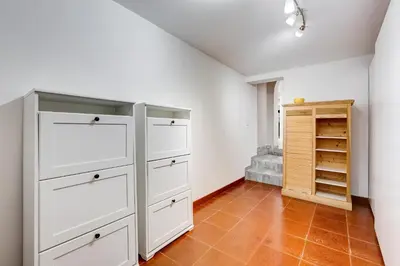a kitchen with white cabinets and a tiled floor at LuxurySistersHouse 2 min Colosseum in Rome