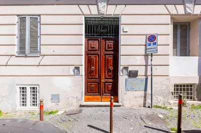 a building with a large wooden door on a building at LuxurySistersHouse 2 min Colosseum in Rome