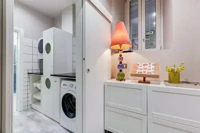 a white laundry room with a washer and dryer at LuxurySistersHouse 2 min Colosseum in Rome
