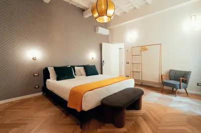 a bedroom with a large bed and a chair at Casa Mia Navona in Rome
