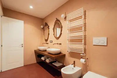 a bathroom with a sink and a toilet and a mirror at Casa Mia Navona in Rome