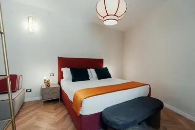 a small bedroom with a bed and a stool at Casa Mia Navona in Rome