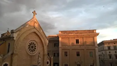 an old building with a statue on top of it at Around The Corner Colosseo B&B in Rome