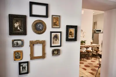 a wall with framed pictures on a wall at Ale & Niki's Home in Rome