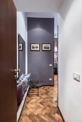 a living room with a couch on a wooden floor at Vite Suites Guest House in Rome