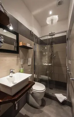 a bathroom with a sink and a toilet and a shower at Vite Suites Guest House in Rome