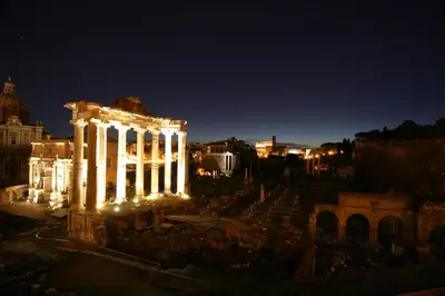 a night view of the acropolis with lights at Vite Suites Guest House in Rome