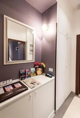 a dressing room with a mirror and a white cabinet at Vite Suites Guest House in Rome