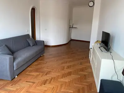a living room with a couch and a television at La Casa di Ester Three-room apartment in Rome