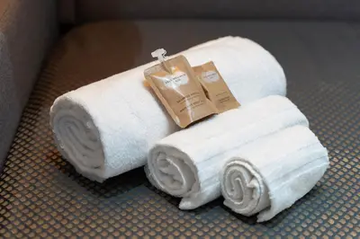 two rolls of white towels sitting on a floor at RomanticRome, elegant apartment in Trastevere district in Rome