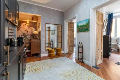 a room with a kitchen and a living room at RomanticRome, elegant apartment in Trastevere district in Rome